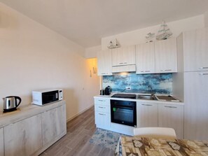 Fridge, microwave, stovetop, coffee/tea maker