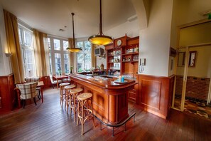 Relax in style at our elegantly designed bar area, featuring a classic counter, comfortable seating, and warm ambiance.