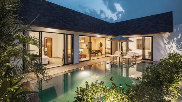 A modern house with a swimming pool, large glass doors, and a patio area. - Rocca Bella Villa 2 by Alfred in Bali (Canggu)