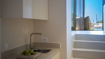 Deluxe Quadruple Room | Living area | 49-inch Smart TV with satellite channels