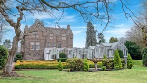 A large stone building with multiple windows and a conservatory with glass roofs. - The Landmark Hotel and Leisure Club | SUPR DBL (Dundee)