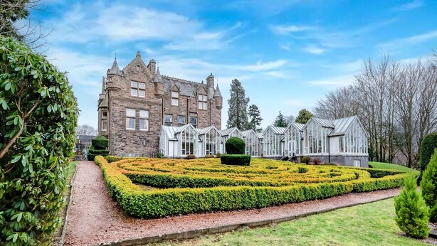 A historic stone building with a symmetrical garden featuring a maze and neatly trimmed hedges. - The Landmark Hotel and Leisure Club | SUPR DBL (Dundee)