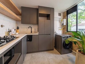 Fridge, microwave, coffee/tea maker, cookware/dishes/utensils