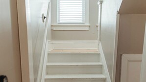A staircase leading to a landing with a window above.