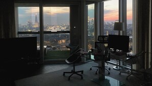 A modern office space with large windows offering a city view.