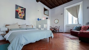 A bedroom with a bed, a desk, a chair, a sofa, and a large window. - Inn Pantheon home lovely apartment 50 meters from the Pantheon (Roma)