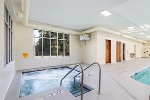 A swimming pool with a 3-foot depth marker, a window, and a door.