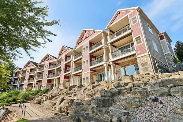 A multi-story hotel with balconies and a stone facade.
