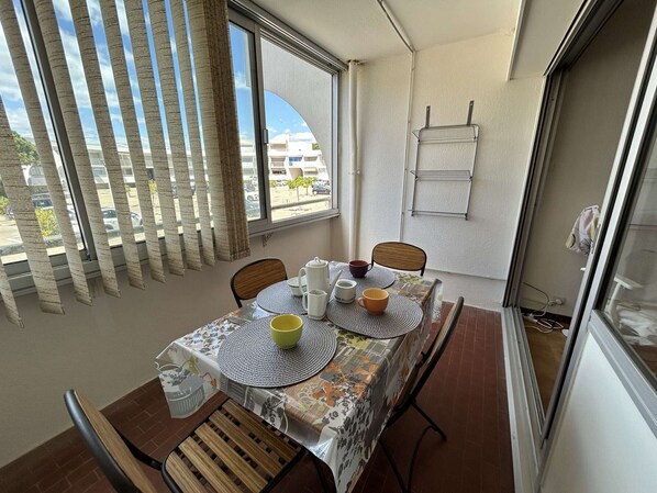 Enjoy meals for two in this cozy dining area with a table set and comfortable chairs.