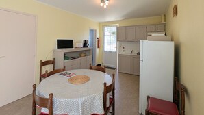 A compact kitchen with a refrigerator, microwave, and coffee maker. - Cottage by the Creuse River with Private Garden (Ceaulmont)