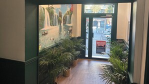 The entrance of Hôtel du Pharo with a mural of a waterfall and swans. - hôtel du Pharo (Marseille)