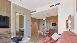 Un soggiorno moderno con un divano, un tavolino da caffè e una TV a parete.