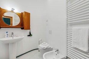 A modern bathroom with a white sink, a mirror, a toilet, and a bidet. - The Arco Round House With Terrace & Parking (Arco)