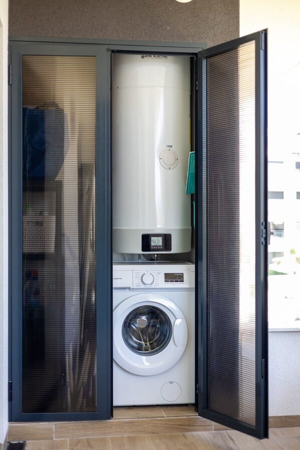 A compact laundry room with a washing machine and a dryer.