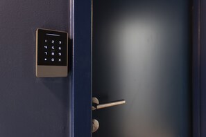 A keypad lock on a door. - Lapa Diplomatic Flat 1 1 by Feel Lisboa (Lisbon)