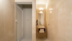 A modern bathroom with a vanity, mirror, and towel rack.