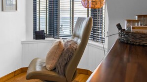 A chair with a fur throw, a window with blinds, and a wicker basket on a wooden floor. - Creel Cottage 4 - Stunning Beach Front Access & Views - Free Parking - Garden (Arbroath)