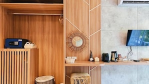 A modern reception area with a wooden desk, a mirror, and a television. - Siri Lagoona Resort & Pool Villa (Bang Lamung)