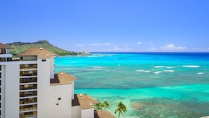 A hotel with a view of turquoise waters and a mountain in the background. - Ocean View 1-bed/2-bath Penthouse Suite at Waikiki Shore! (Honolulu)