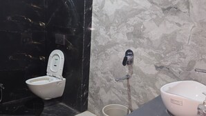 A bathroom with a toilet, bidet, and sink. - Hotel Annapurna (Ratlam)