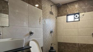 A bathroom with a toilet, sink, and shower. - FARM REGENCY GORAI (Mumbai)