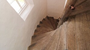 A wooden staircase with white walls and a window. - Catherine Parrs Sewing Room (Bedale)