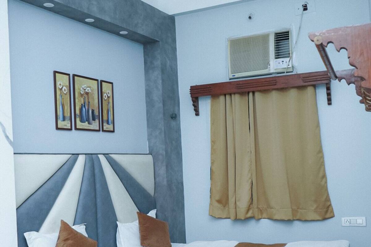 A bedroom with a bed, bedside table, and a ceiling fan.