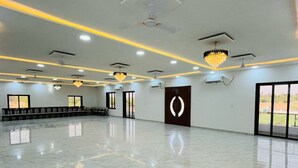 A spacious, well-lit indoor area with a polished marble floor, ceiling lights, and a modern chandelier. - Hotel Shri Tulsi Residency (Phalodi)
