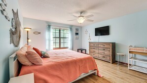 A bedroom with a bed, a dresser, a TV, and a ceiling fan. - Private Pool & Patio: Niceville Family Home (Niceville)