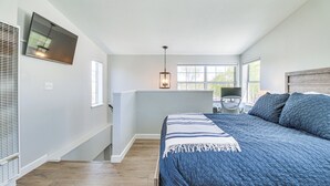 A bedroom with a large bed, a TV mounted on the wall, and a window providing natural light. - Walk to Dtwn Show Low: Townhome w/ Balcony (Show Low)