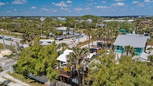 An aerial view of a residential area with houses, a road, and a beach in the foreground. - Marvelous Mermaid Beach Bungalow Dog-friendly (St. Augustine)