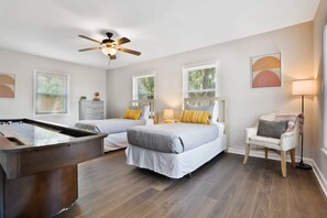 A hotel room with two beds, a pool table, a ceiling fan, and a chair. - Water View Hot Tub Games Fire Pit Boat Parking (St. Augustine)