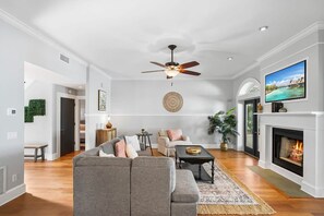 Relax in this inviting living room with a fireplace, flat-screen TV, and comfortable seating area.