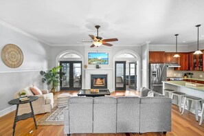 Cozy living space with a central seating area, fireplace, and kitchenette.