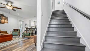 A modern interior with a staircase, wooden flooring, and contemporary furniture. - Pool Spa Downtown by Beach FOY Add Golf Cart (St. Augustine)