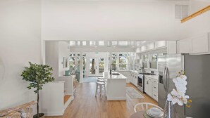 A modern kitchen with a central island, stainless steel appliances, and a view to the outdoors. - Waterfront Incredible Views Fire pit Renovated (St. Augustine)