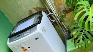 A white portable air conditioner with a digital display, connected to a wall socket. - Relax room: beautiful fish and plants (Cochabamba)