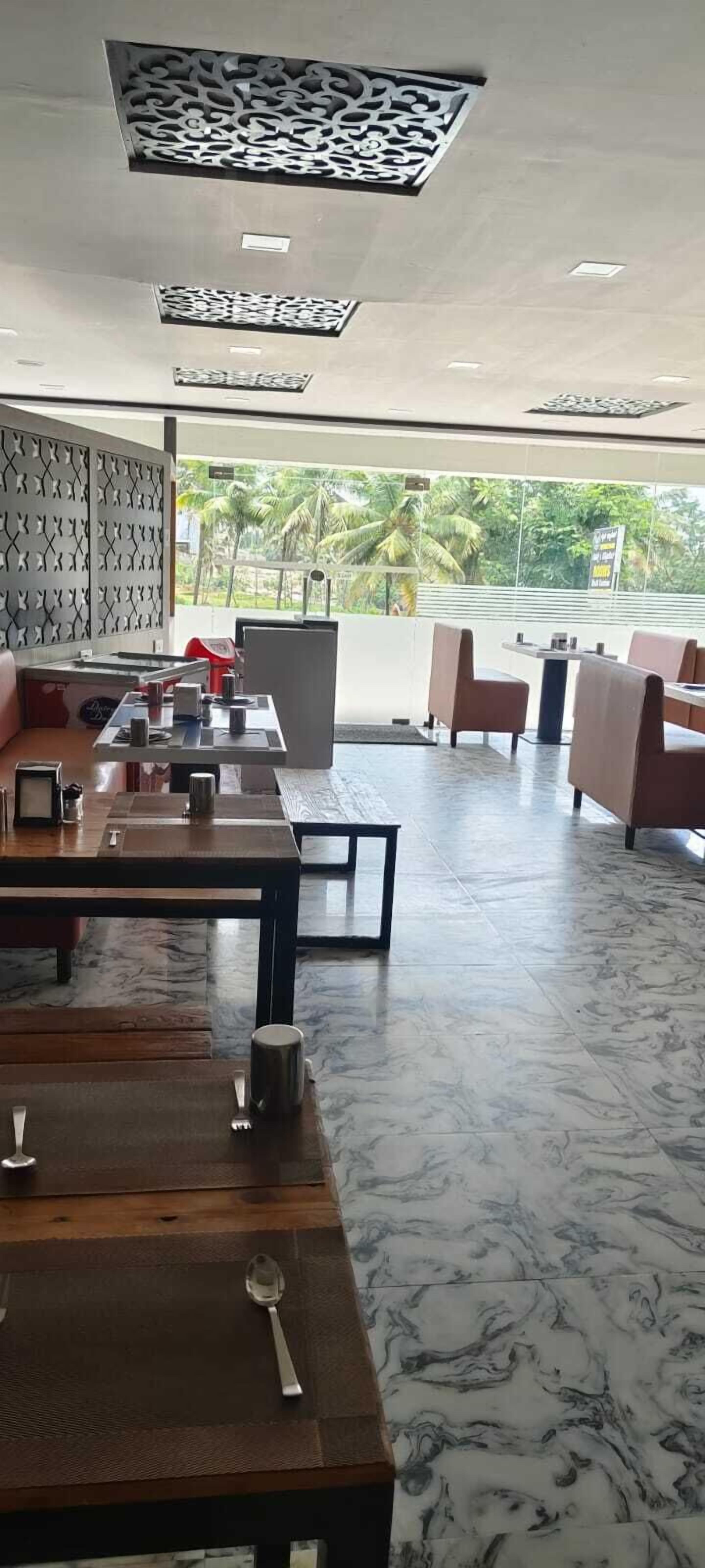 A restaurant with marble flooring, wooden tables, and modern decor.