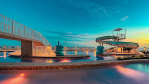 A water park with a bridge, slides, and a pool. - Phoenix Gulf Shores Ii 2104 3 Bedroom Condo (Gulf Shores)