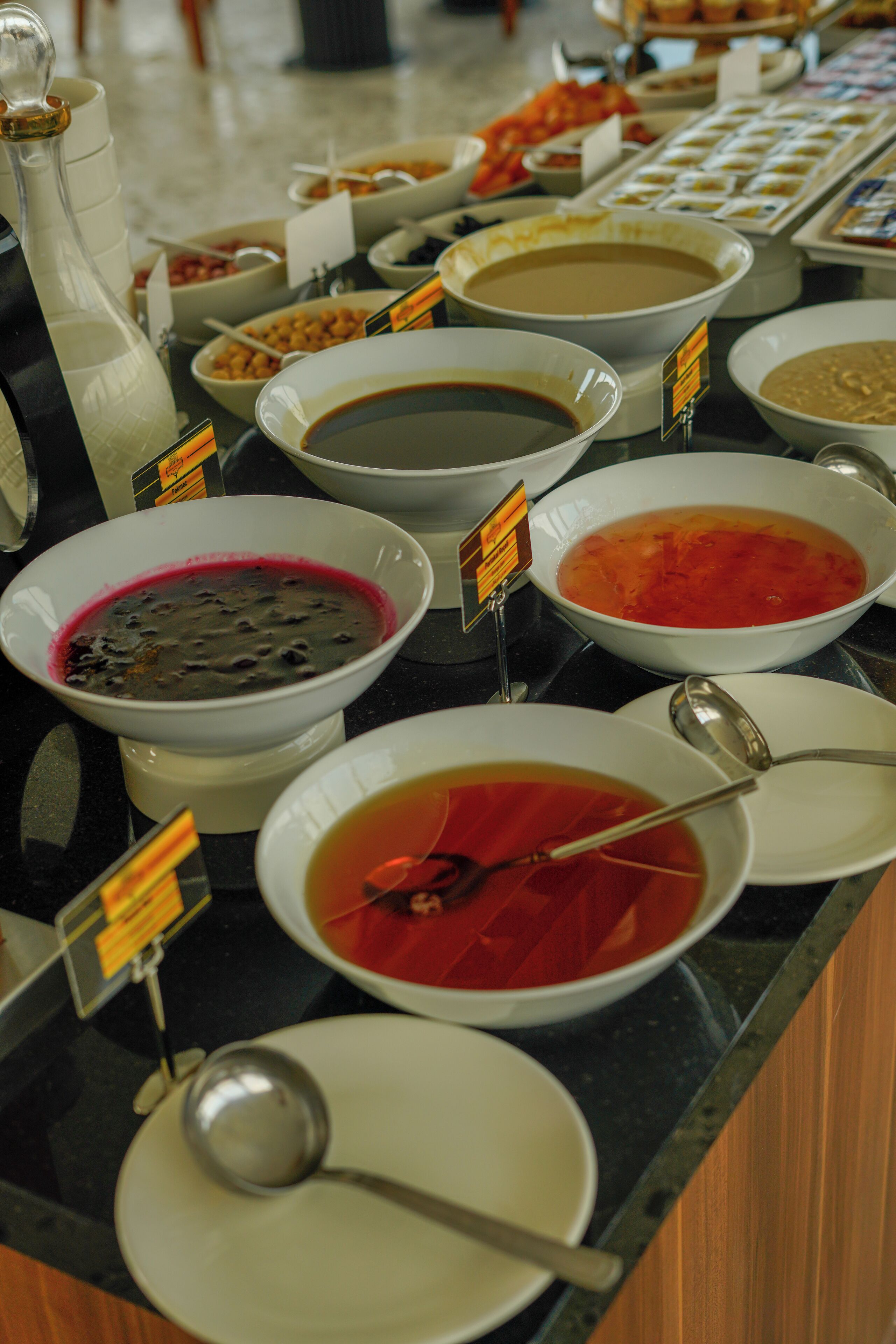 A buffet with various dishes and a bottle of milk.