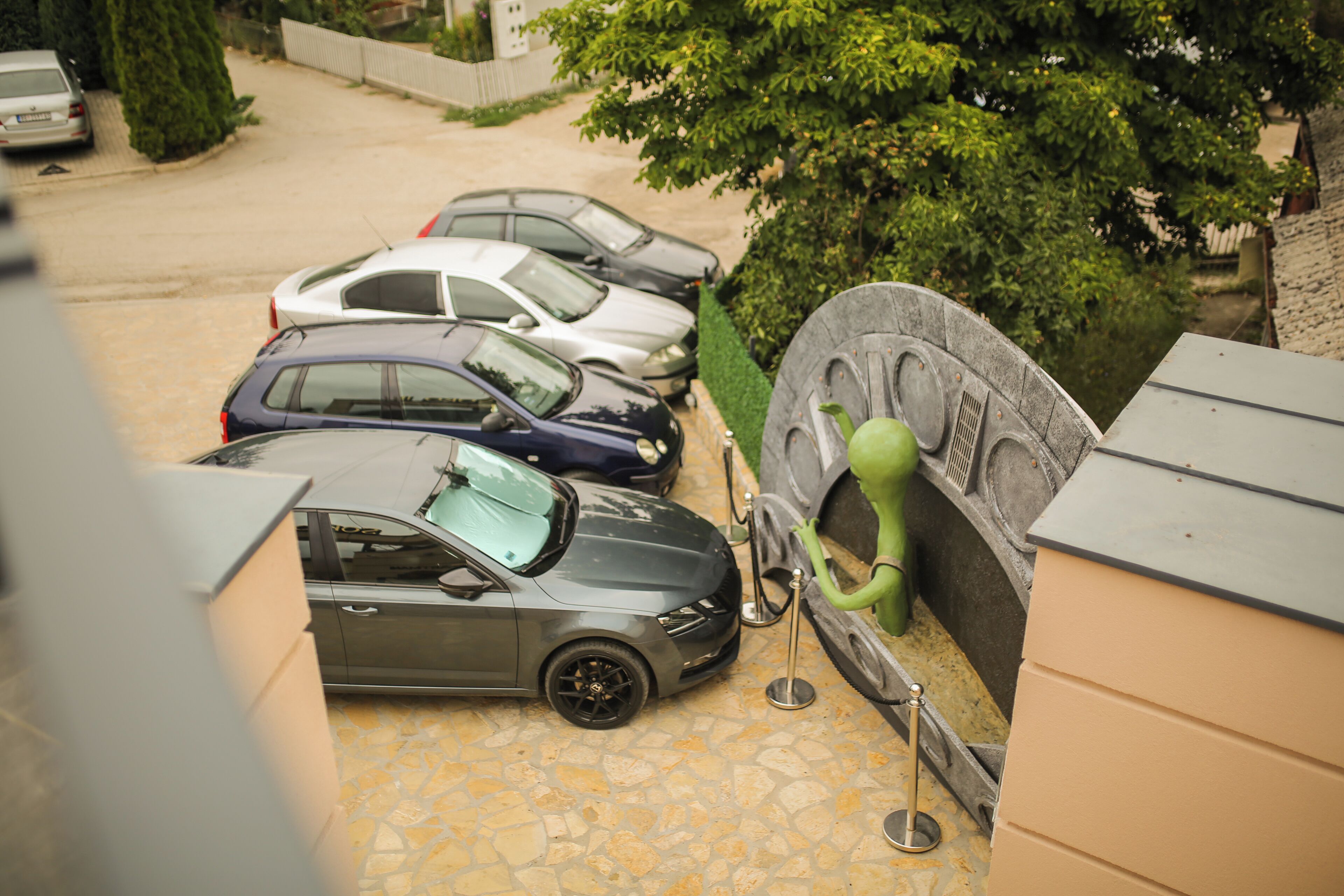 A parking area with multiple cars parked in a row.
