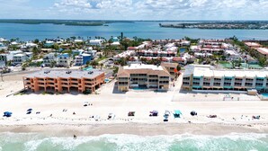 A coastal resort with multiple buildings, a beach, and a view of the ocean.