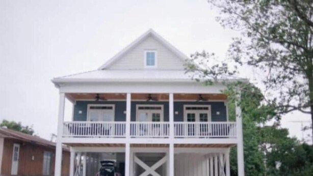 A two-story house with a balcony and a garage. - Large Common Areas, Quiet Street, Golf Cart Available! (Carolina Beach)