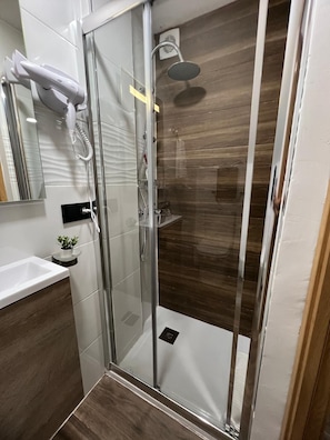 Shower, hair dryer, towels, soap
