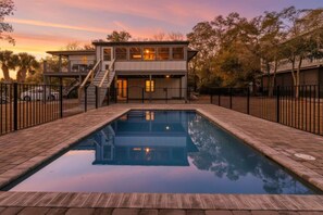 A two-story building with a swimming pool in front.