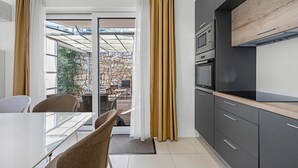 A modern kitchen with dark cabinetry, a built-in oven, and a microwave. - Lovely apartment in Murter with WiFi - CSV284 (Murter)