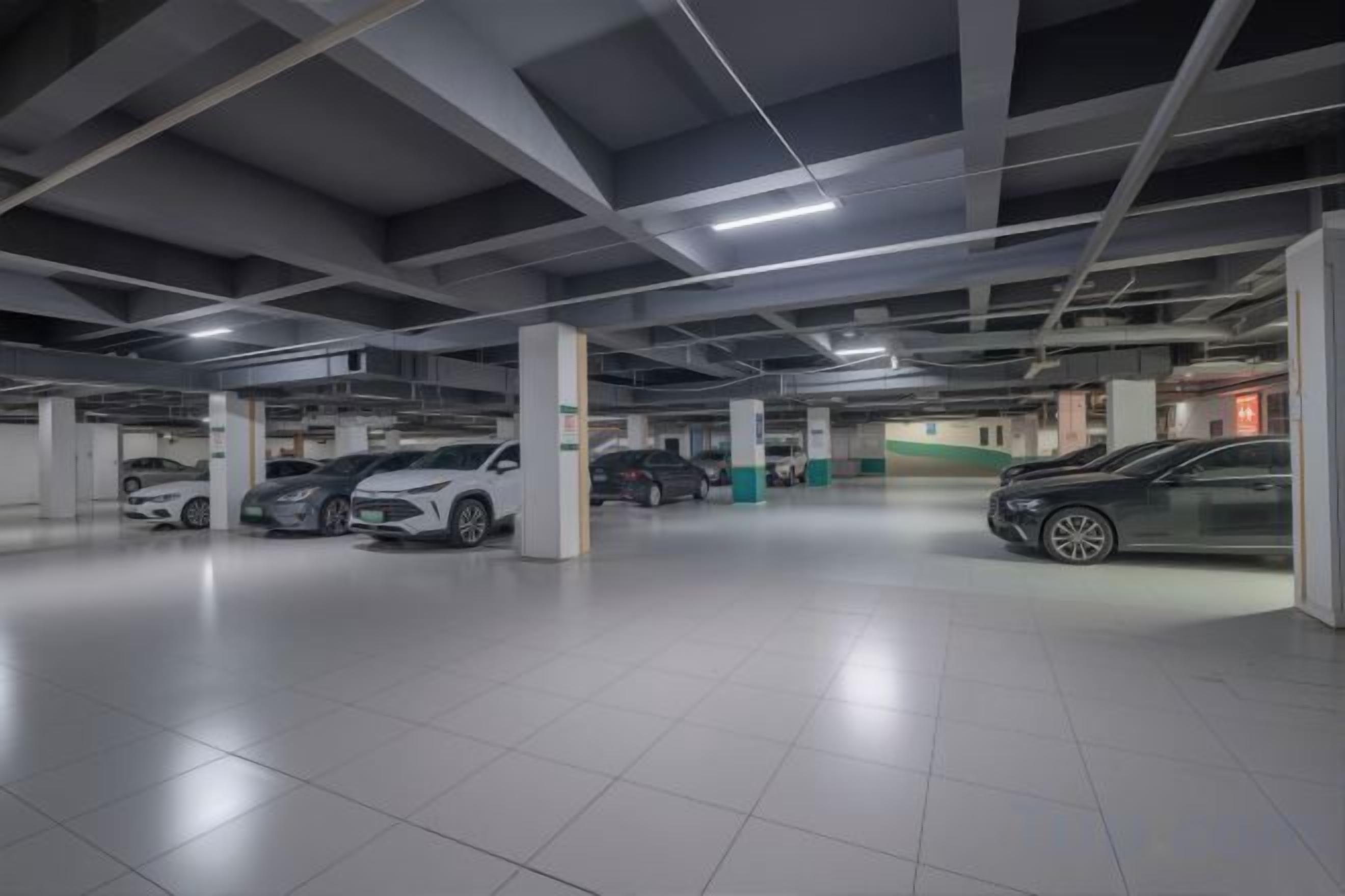 A multi-level parking garage with several cars parked.
