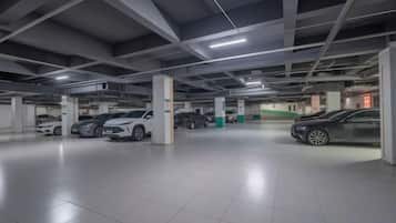 A multi-level parking garage with several cars parked.