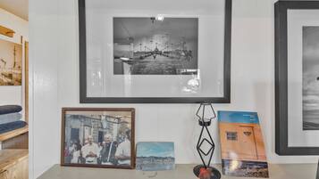 A wall with framed photographs and a book.