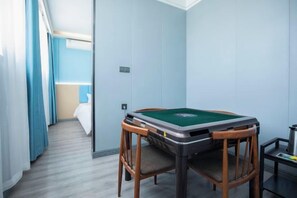 A room with a pool table, a bed, and a window with curtains. - Qingmu Hotel(Shangyuan Street,Dongshan Subway Station,Nanjing) (Nanjing)
